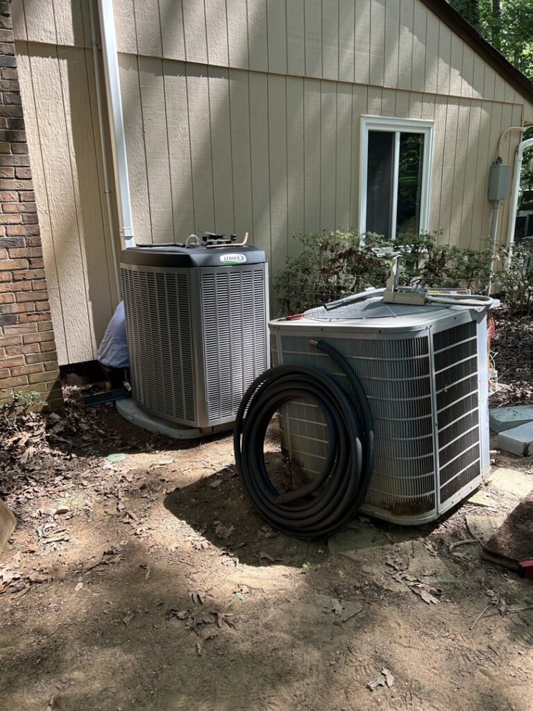 Old and new outdoor AC units, likely a replacement project by Eveready Service Experts in Henrico, VA.