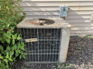 An older Armstrong Air outdoor air conditioner unit, ready for service or replacement by I & M Heating and Cooling in South Bend, IN.