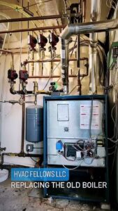 An old boiler system with complex piping, indicating a replacement project by HVAC Fellows in Boston, MA.