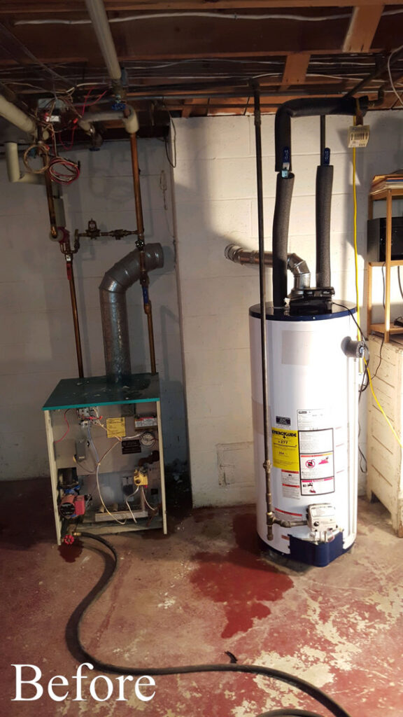 An old boiler and water heater setup before replacement by Nimmer Heating & Air Conditioning in Milwaukee, WI