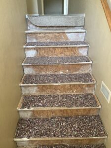 Old carpet and padding being removed from stairs by Mark Hart Flooring Consultant at RM Interiors & Design in Mesa, AZ.
