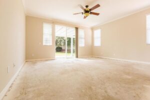 An empty room showing old carpet removed and subfloor exposed, indicating preparation for new carpet installation or deep cleaning by stpaulbestcarpetcleaners.com in Saint Paul, MN.