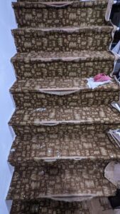 Old carpet removal from a staircase, a carpet contractor job in progress by National Carpet and Flooring in Tyngsboro, MA.