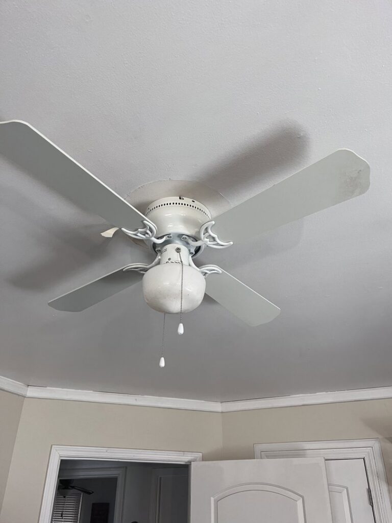 An older model ceiling fan with lights, indicating potential replacement service by Geter Electrical Services LLC in Fountain Inn, SC.