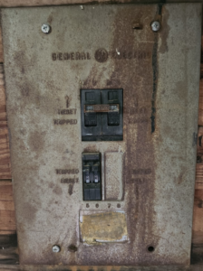 An old circuit breaker panel, ready for inspection or upgrade by Steele Electric Service in Forest Grove, OR.