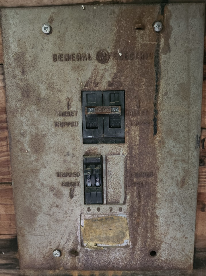 An old circuit breaker panel, ready for inspection or upgrade by Steele Electric Service in Forest Grove, OR.