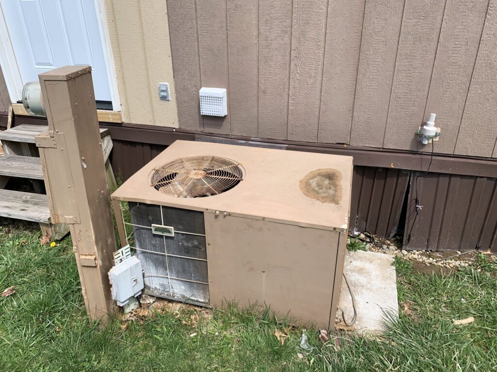 An old and dirty outdoor HVAC unit in need of repair or replacement from PureAir HVAC in Bel Air, MD.