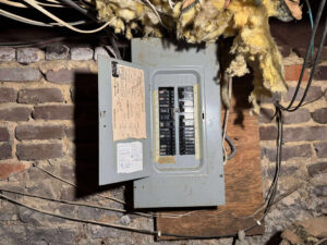 An old electrical breaker panel in a home, a common service area for Mister Sparky of Greensboro in Greensboro, NC.