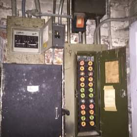 An old electrical panel with fuses and components serviced by Crown Enterprises Electrical Contracting in Omaha, NE.
