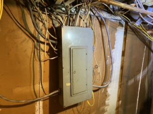 Old electrical panel and wiring needing service by Empower Electrical, LLC in Fall River, MA