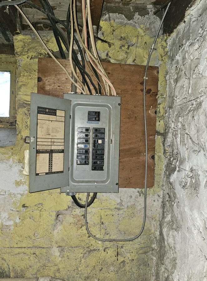 An old, open electrical panel with exposed wiring, ready for upgrade by Joey G Electric LLC in Waterbury, CT.