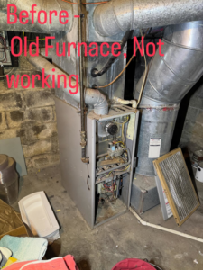 An old, non-working furnace in a basement before replacement by Inspired Heating & Cooling, Electric, Roofing, Repair LLC in Columbus, OH.