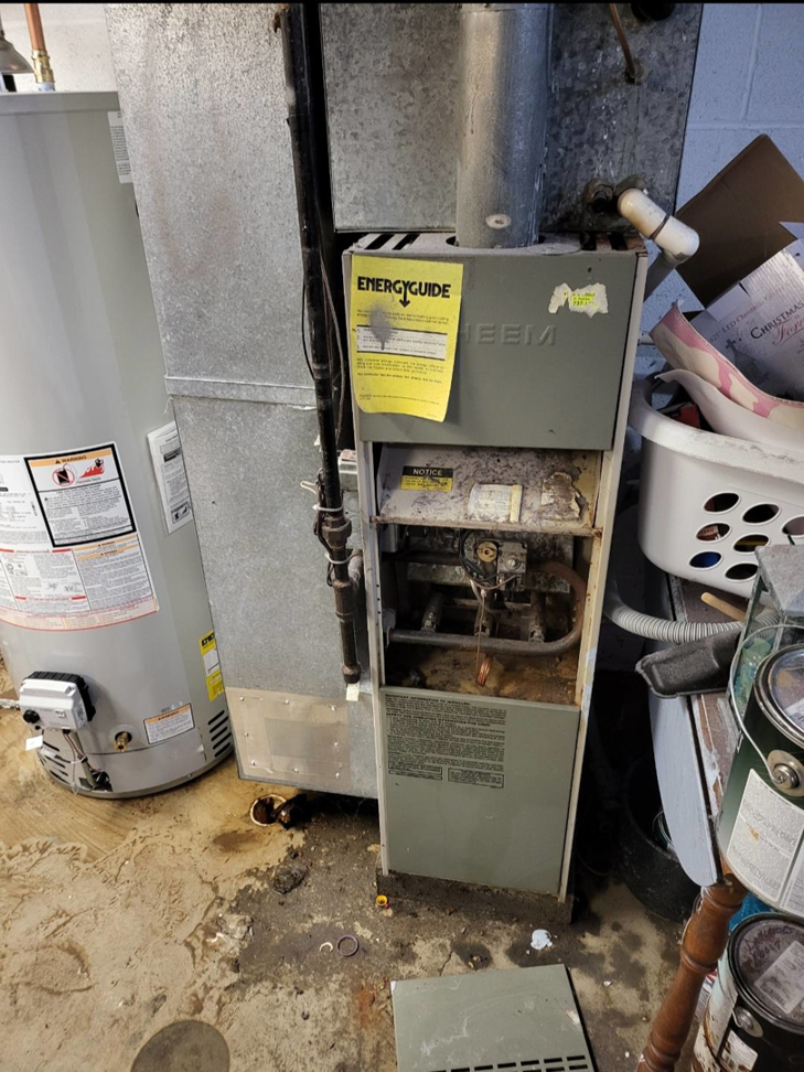 An old, dirty furnace awaiting inspection or replacement by Orchard Heating-Cooling and Sheet Metal in Stow, OH.
