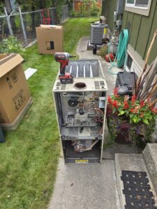An old furnace with exposed components, ready for replacement or service by 406 Heating & Cooling LLC in Missoula, MT.