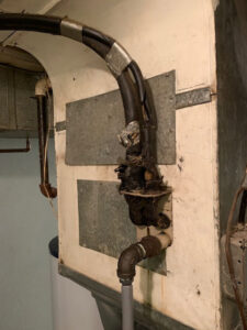 Close-up of old and damaged wiring and piping on an existing furnace or air handler, indicating a need for HVAC repair by Matt Moeller Heating and Cooling Llc in Stewartville, MN