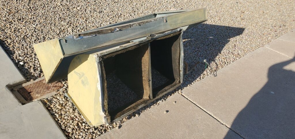 Old HVAC ductwork removed from a roof and placed on the ground for replacement by Ash Cooling & Heating in Mesa, AZ.