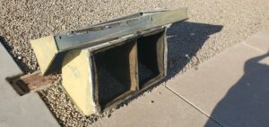 Old HVAC ductwork removed from a roof and placed on the ground for replacement by Ash Cooling & Heating in Mesa, AZ.