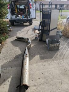 Old HVAC ductwork and equipment being removed after a service job by Arrowseal of Billings HVAC in Billings, MT.