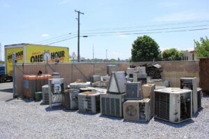 A pile of old HVAC units and scrap metal ready for disposal by One Hour Heating & Air Conditioning of Lancaster, PA.