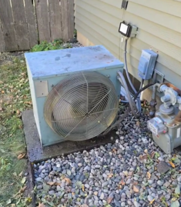 An old outdoor AC unit, part of an HVAC system, at a residential property by EZ AIR HVAC in San Antonio, TX