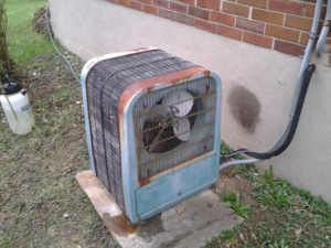 An old, rusty outdoor air conditioning unit, representing a common repair or replacement job for Jacob Bros. Heating & Air Conditioning in Cincinnati, OH.