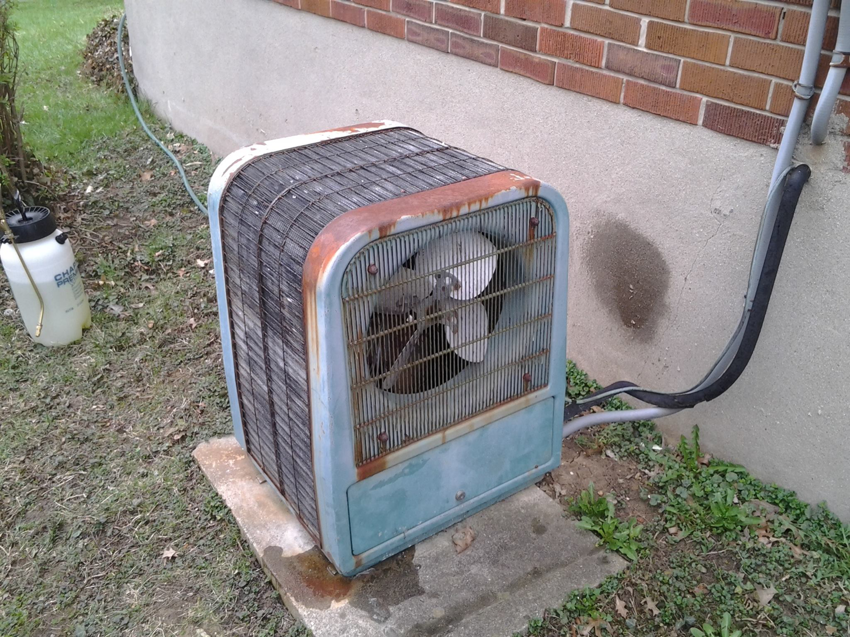 An old, rusty outdoor air conditioning unit, representing a common repair or replacement job for Jacob Bros. Heating & Air Conditioning in Cincinnati, OH.