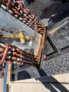 An old, rusty HVAC coil, indicating a need for replacement or service by Bluestone Refrigeration LLC in Las Cruces, NM.