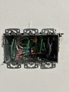 Before and after of an old electrical outlet replaced with a new one by MV Electrical LLC in Phoenix, AZ.