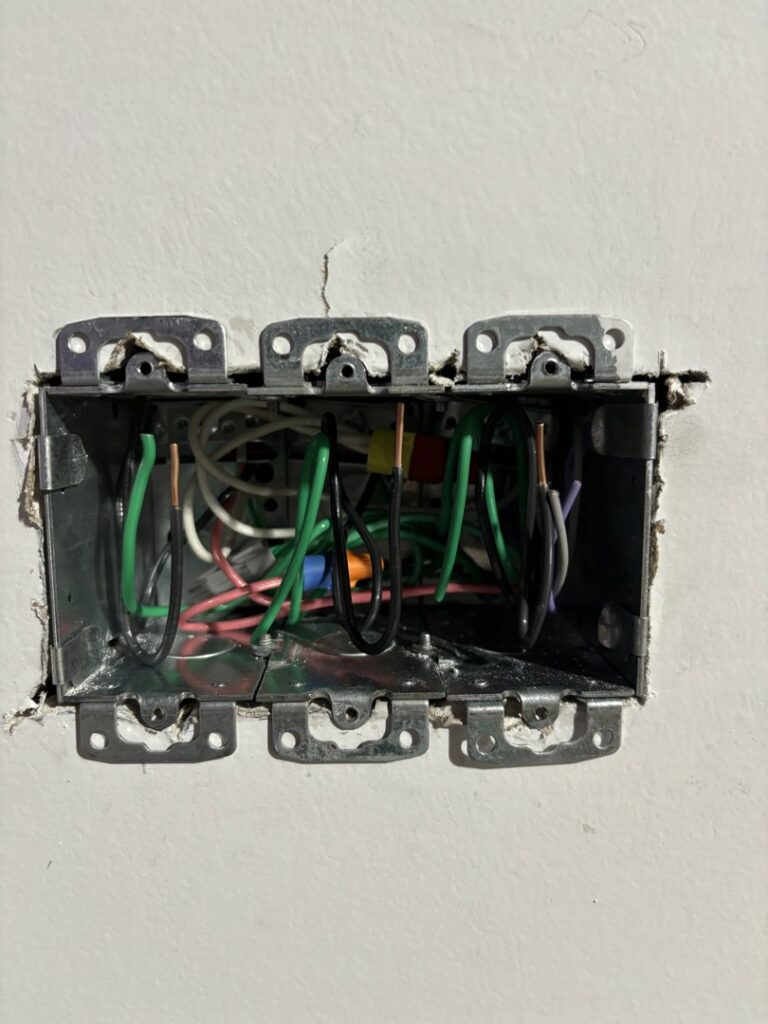 Before and after of an old electrical outlet replaced with a new one by MV Electrical LLC in Phoenix, AZ.