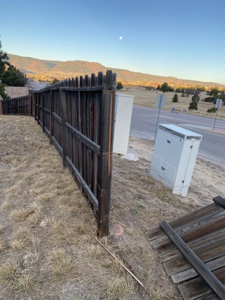 An old, weathered wood fence in need of repair or removal by Red Dirt Fencing and Woodwork, LLC in Fountain, CO.