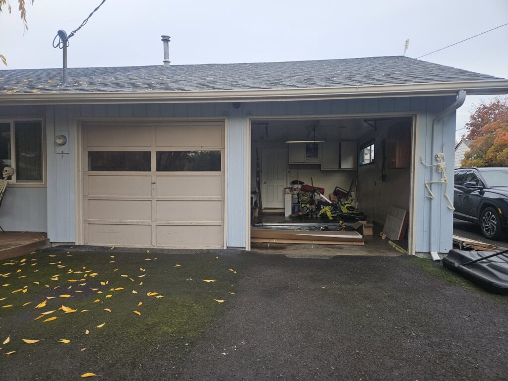 An inside view of an old wooden garage door, potentially needing replacement or repair by Alliance Overhead Garage Doors Inc. in Portland, OR.