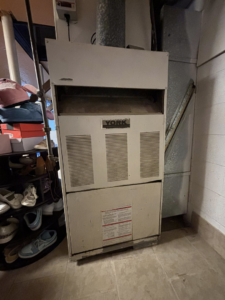 An old York brand HVAC furnace unit, ready for replacement or service by Arctic Desert Cooling & Heating in Concord, NC