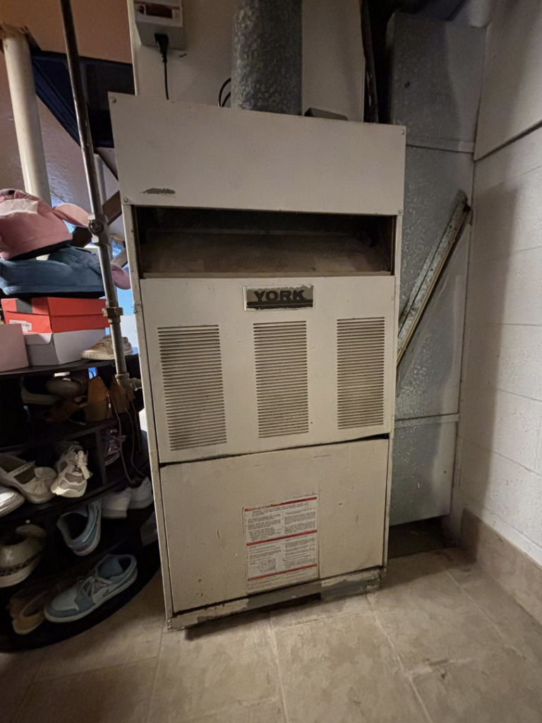 An old York brand HVAC furnace unit, ready for replacement or service by Arctic Desert Cooling & Heating in Concord, NC