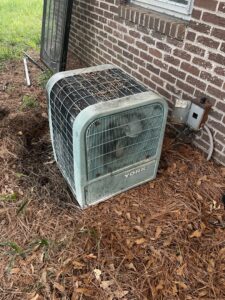 An old and dirty York outdoor HVAC unit, likely in need of replacement or significant service from DeltaCool in Jonesboro, AR.