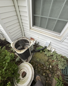 An older outdoor AC unit being serviced by Progressive Heating and Cooling WNY in Buffalo, NY.