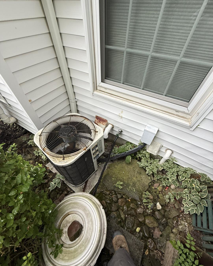 An older outdoor AC unit being serviced by Progressive Heating and Cooling WNY in Buffalo, NY.