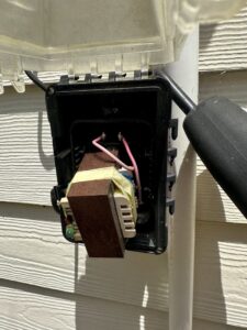 An open electrical box with wiring and a transformer, serviced by All Service Electric in Jacksonville, FL.