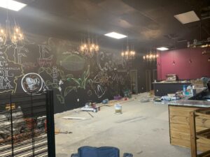 An open electrical breaker panel with circuit labels, indicating inspection or service by Border Electrical Contractor LLC in Nashua, NH.