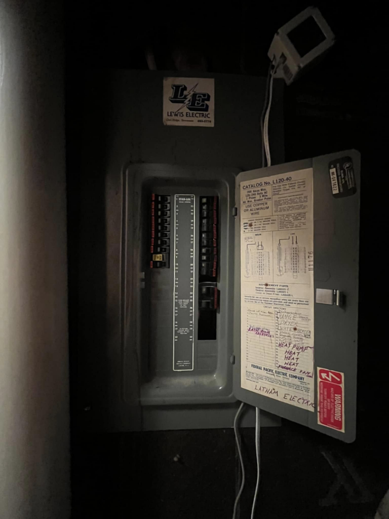 An open electrical breaker panel showing wiring and labels, serviced by Mayflower Electric LLC in Knoxville, TN