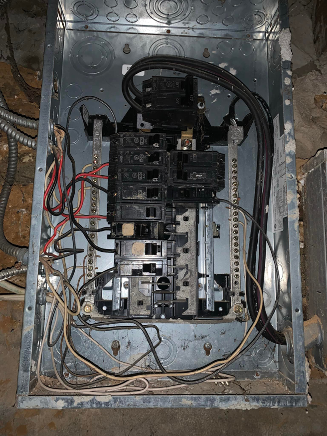 An open electrical breaker panel with circuit breakers and wiring, serviced by MDMartin Electrical LLC in Philadelphia, PA.