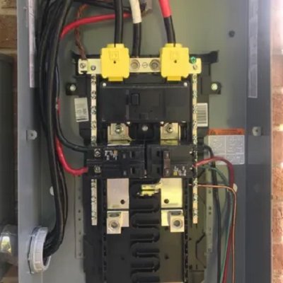 An open electrical breaker panel showing wiring and circuit breakers, serviced by Brian Jackson Electrical Service LLC in Sadler, TX