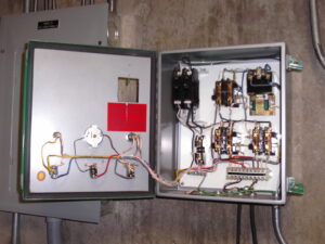 An open electrical control panel with various wires and components, serviced by Mr. Electric of Vancouver, WA.