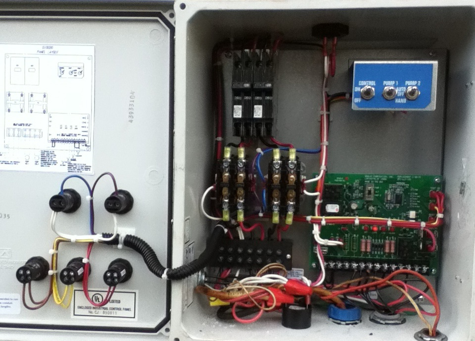 An open electrical control panel with complex wiring and circuit breakers, serviced by Electriciansonway in Hollywood, FL