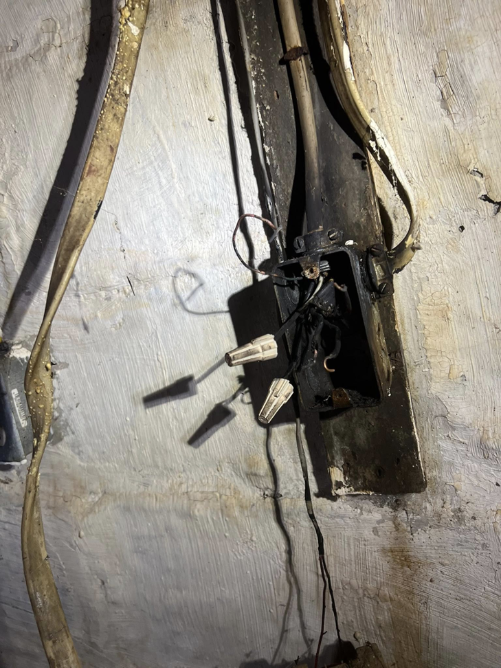 An open electrical junction box with severely burnt wires and wire nuts, requiring service from KNK Electric in Pittsburgh, PA.