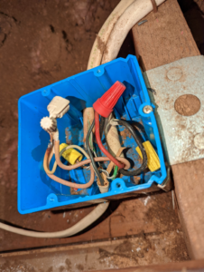 An open electrical junction box revealing complex wiring and wire nuts, handled by The Wire Guy in San Jose, CA.