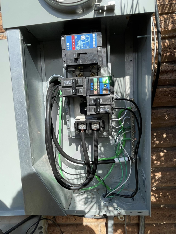 An open electrical meter panel showing breakers and wiring by Savoski's Electrical & AC, LLC in Sunset, LA