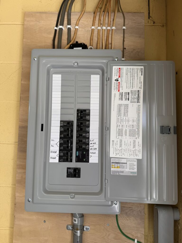 An open electrical panel or breaker box showing wiring and circuit breakers, serviced by LeBrun Electric, Heating & Cooling in Brooklyn Park, MN.