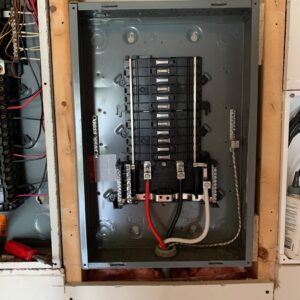 An open electrical panel or breaker box showing wiring and circuit breakers, serviced by Phoenix Electric, Inc. in Cape Coral, FL