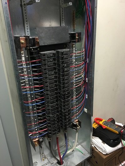 An open electrical panel displaying circuit breakers and wiring, a job performed by Esmeralized Electric in San Jose, CA.