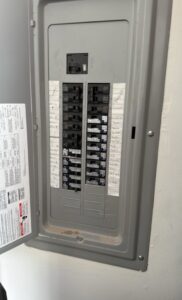 An open electrical panel displaying labeled circuit breakers, serviced by Geter Electrical Services LLC in Fountain Inn, SC.